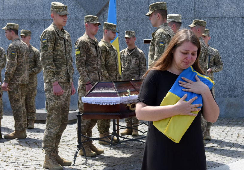 The sister of Oleksiy Tarasev mourns during the funeral ceremony for Ukrainian servicemen Oleksiy Tarasev, Ihor Skakun and Rostyslav Tomkiv in Lviv on June 1